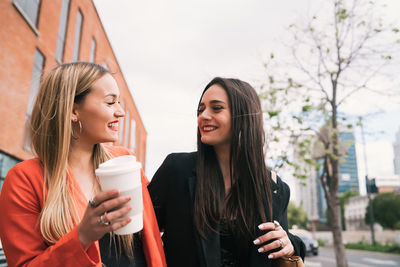 Portrait of beautiful young woman drinking outdoors