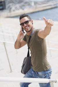 Portrait of man talking on mobile phone in city