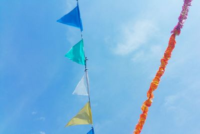 Low angle view of colorful buntings against sky