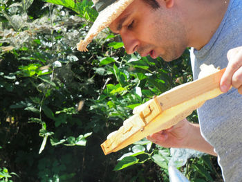 Side view of young man working on field