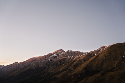 Low angle view of snowcapped mountain against sky