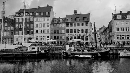 Boats in canal with buildings in background