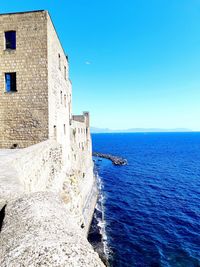 Scenic view of sea against clear blue sky, old castle on sea, castel dell'ovo view in naples,