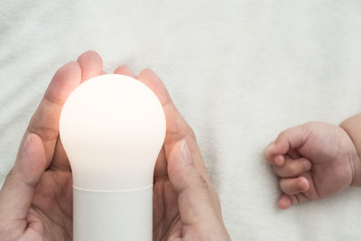 Cropped image of woman holding hands over white background