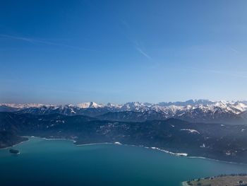 Scenic view of snowcapped mountains against blue sky