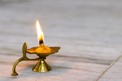 Close-up of lit candles on table