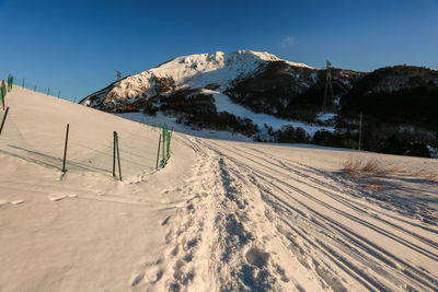 Scenic view of snowcapped mountains against clear sky