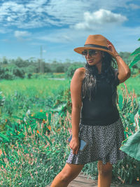 Midsection of woman standing on field