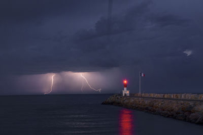 Scenic view of sea against sky at night
