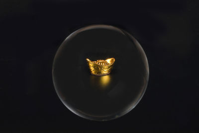 High angle view of illuminated light bulb against black background