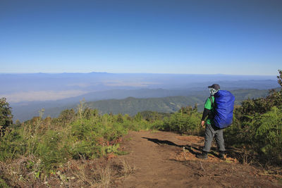 Man hiking traveler with big backpack mountaineering travel lifestyle