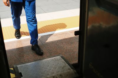 Low section of man standing on floor