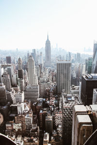 Aerial view of buildings in city against clear sky