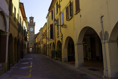 Narrow street amidst buildings in city