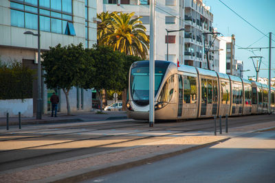 View of train on road by building