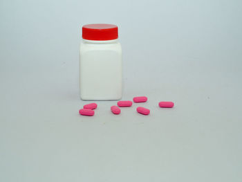 High angle view of pink bottles on table