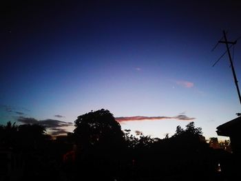 Low angle view of silhouette trees against sky at sunset