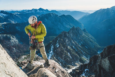 Man standing on rock by mountains