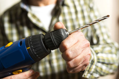 Close-up of man holding work tool