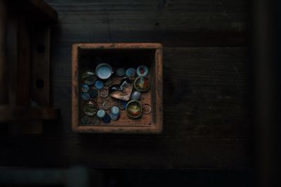 High angle view of objects in box on wooden table