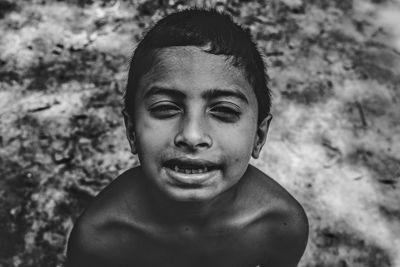 Close-up portrait of boy standing on footpath