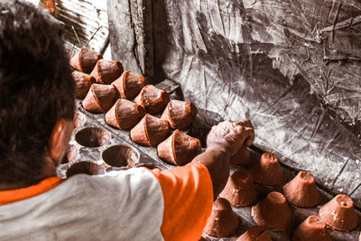 Rear view of man working on rock