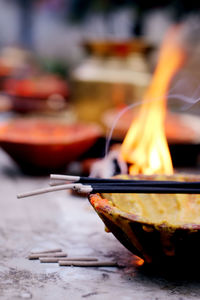 Close-up of incense on container