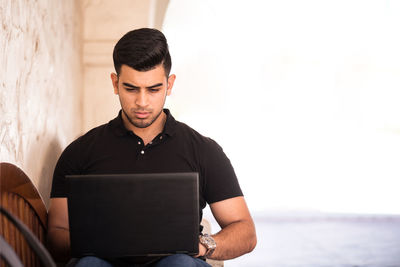Portrait of man using a laptop