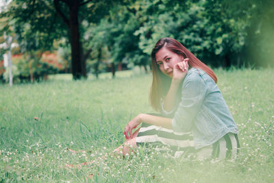 Side view of young woman on field