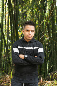 Young latin man in the middle of a beautiful bamboo forest in the majestic colombian mountains