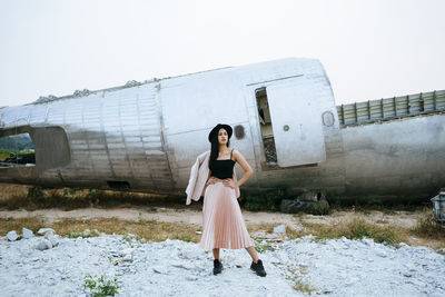 Full length portrait of woman standing against clear sky