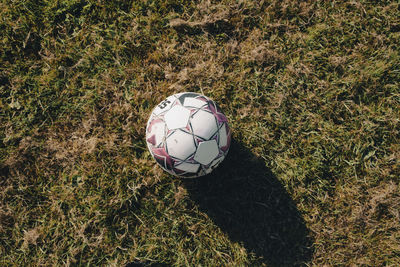 High angle view of soccer ball on grassy field