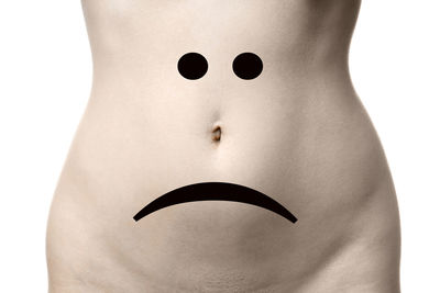 Close-up of woman standing against white background