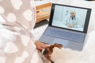 Man using laptop on bed