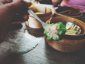 Close-up of hand holding food on table