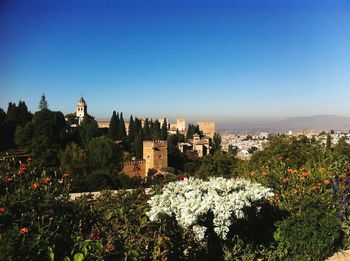 View of cityscape against clear blue sky