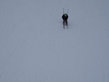 High angle view of person skiing on snow covered field