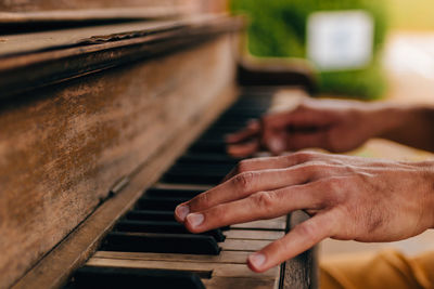 Cropped hands playing piano