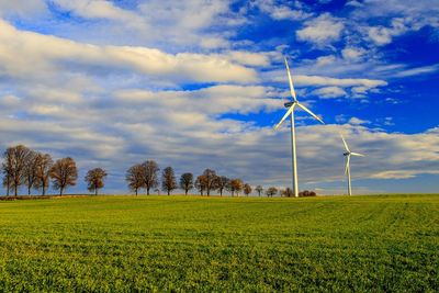 Windmill on field against sky