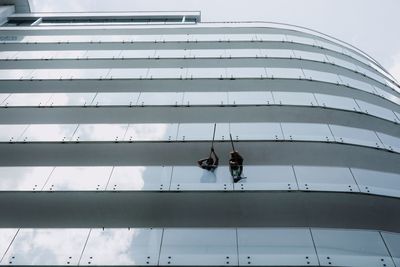 Low angle view of people in modern building