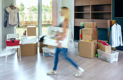 Blurred motion of woman walking in corridor