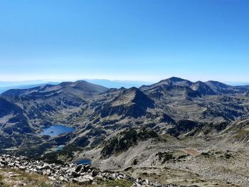 Scenic view of mountains against clear blue sky