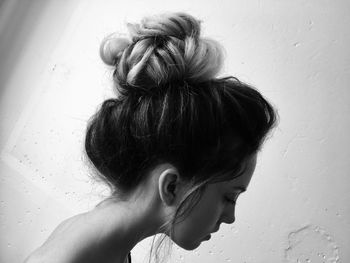 Close-up portrait of woman against wall