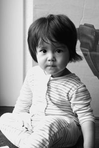 Portrait of cute girl sitting at home