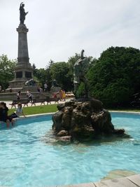 Statue in front of sea