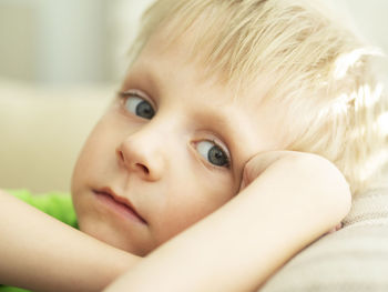 Close-up portrait of cute baby lying on bed