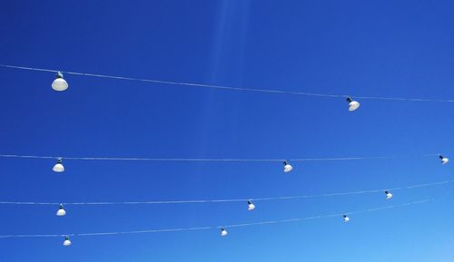 Low angle view of vapor trail against clear blue sky