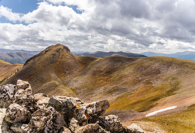 Scenic view of mountains against cloudy sky