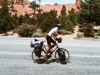 Man riding bicycle on road in city