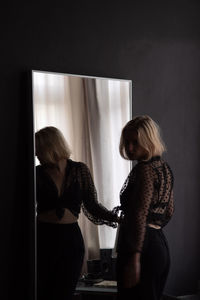 Young woman reflecting on mirror at home